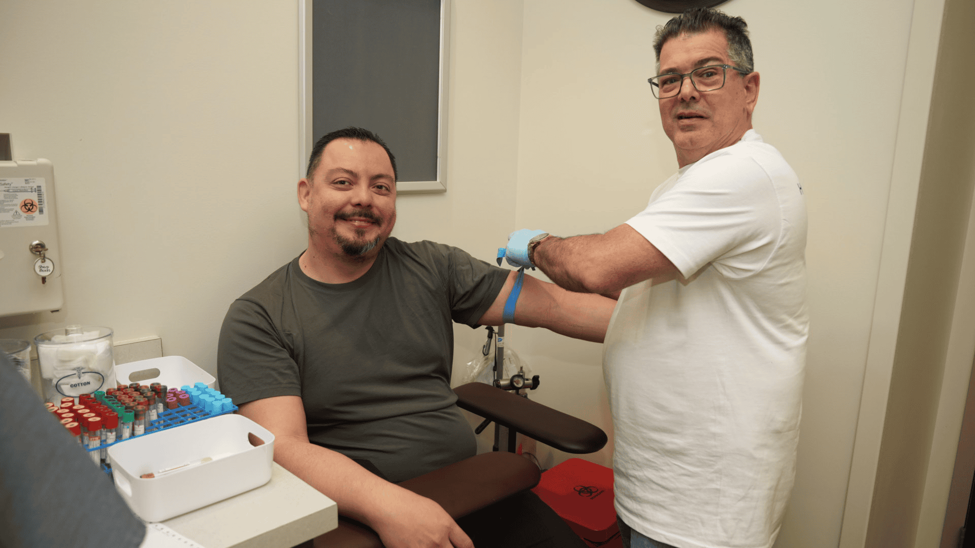 Phlebotomist drawing a blood sample for lab work and physical exams at PassQual Health in Miami Gardens