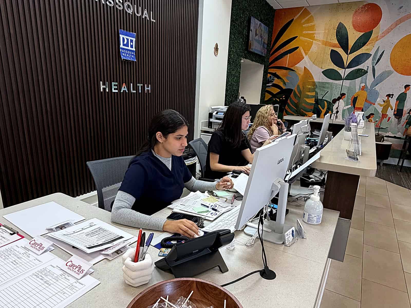 PassQual Health bilingual front desk team welcoming patients