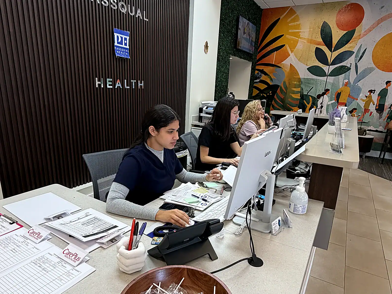 PassQual Health bilingual front desk team welcoming patients