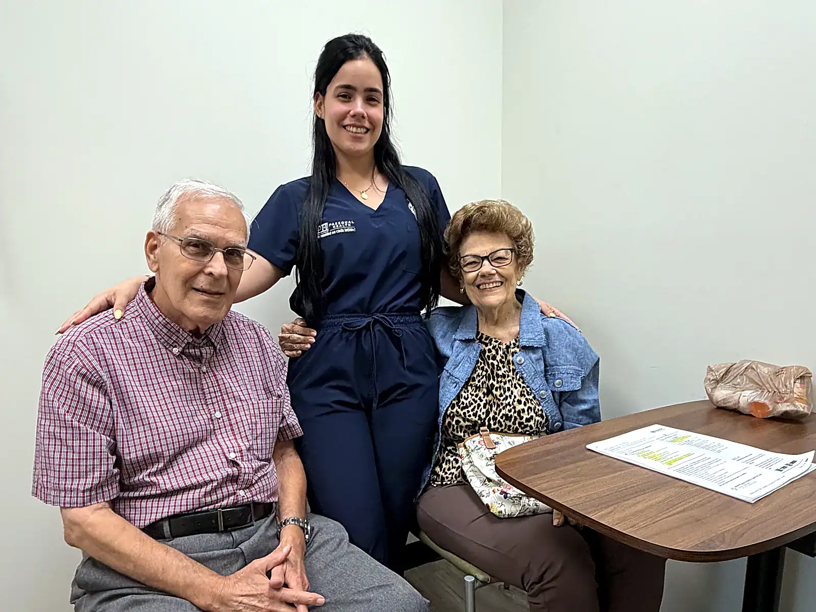 PassQual Health team member with senior patients in an exam room