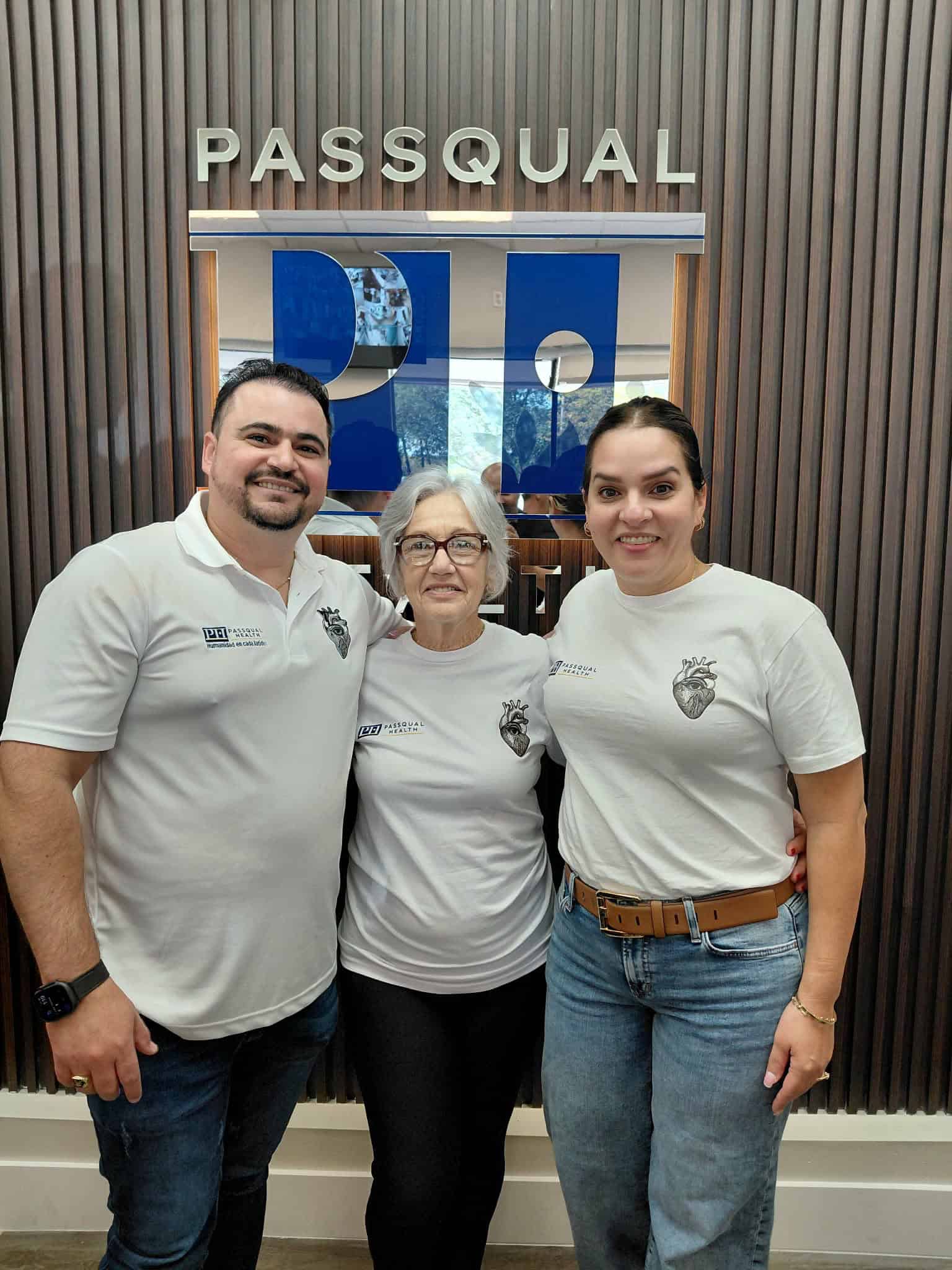 PassQual Health medical team with staff in front of clinic logo.
