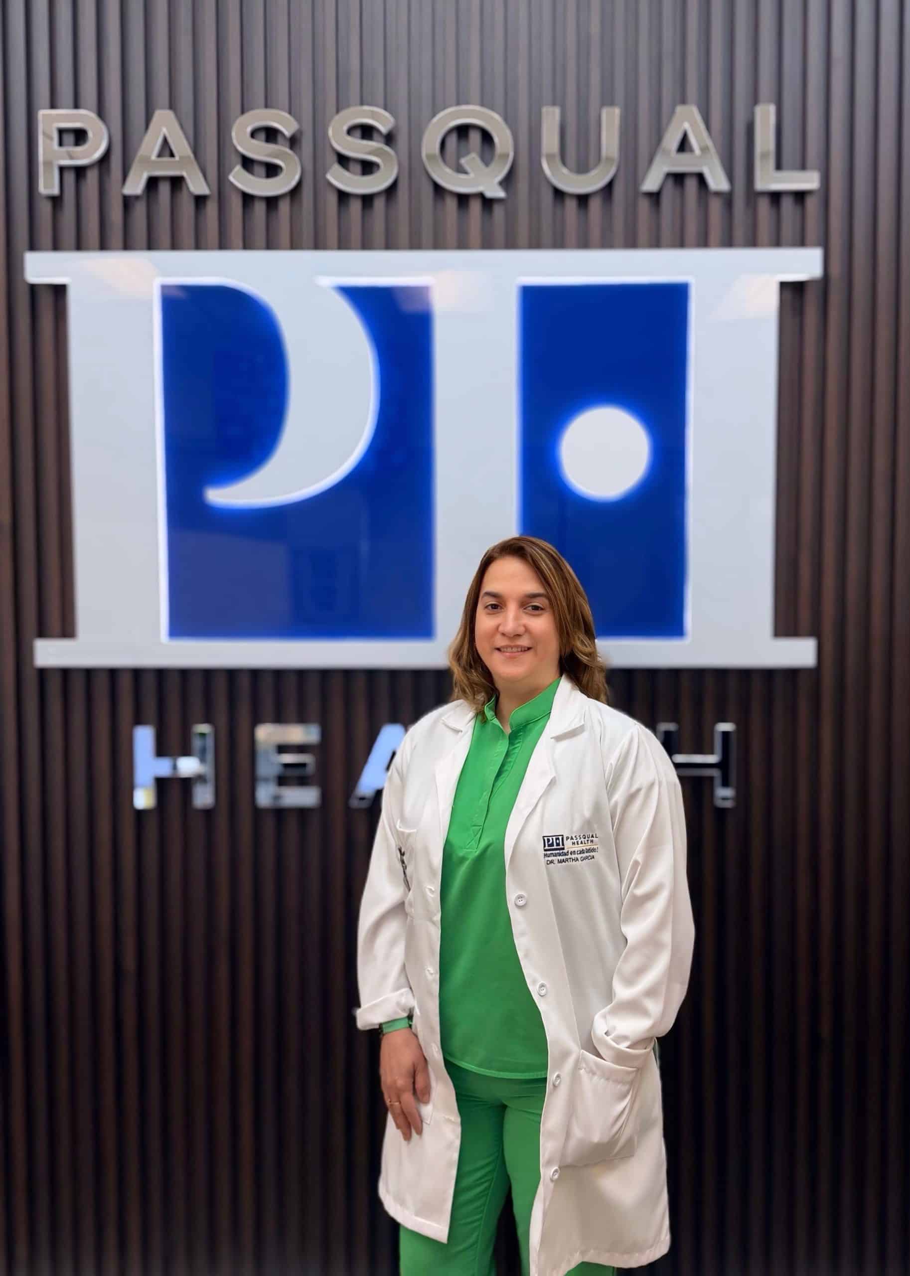 Portrait of Martha Garcia Miranda, APRN, Chief Medical Officer at PassQual Health, wearing a white coat