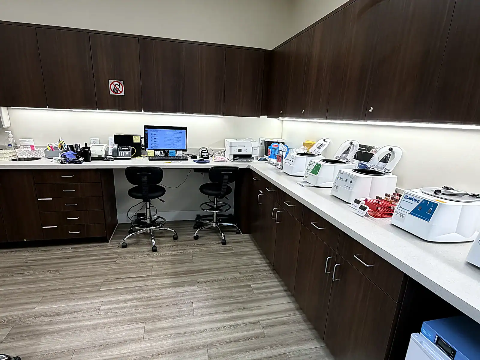 Inside PassQual Health's in-house medical laboratory in Miami Gardens, showing lab equipment and a specimen processing area