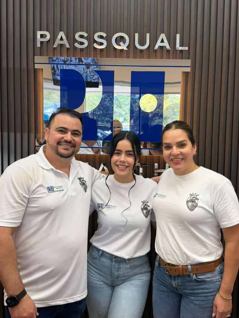 PassQual Health team photo with staff in white uniforms.