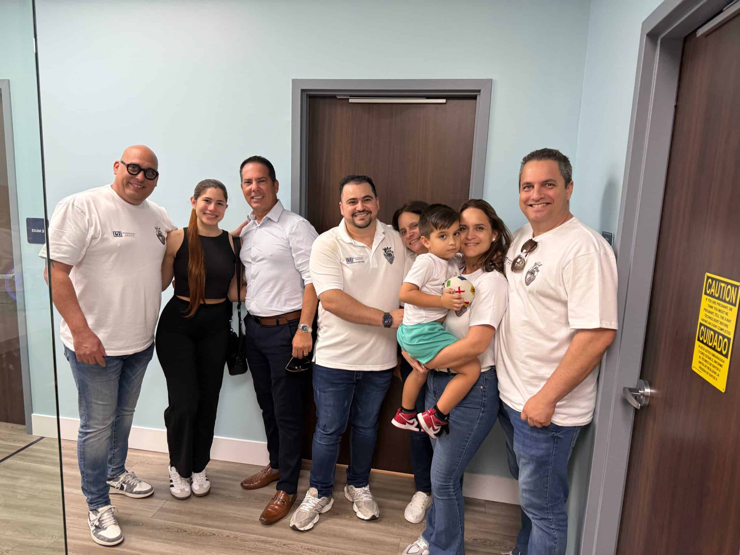 Group of healthcare professionals and a family in a medical facility.